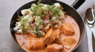 Catfish stew with cheese curd choux, bacon crumbs, sour cream
