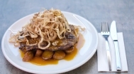 Grilled ribeye steak with onions, roasted potatoes 