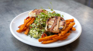 Grilled goat cheese wrapped in bacon, served with sweet potato fries and mixed green salad